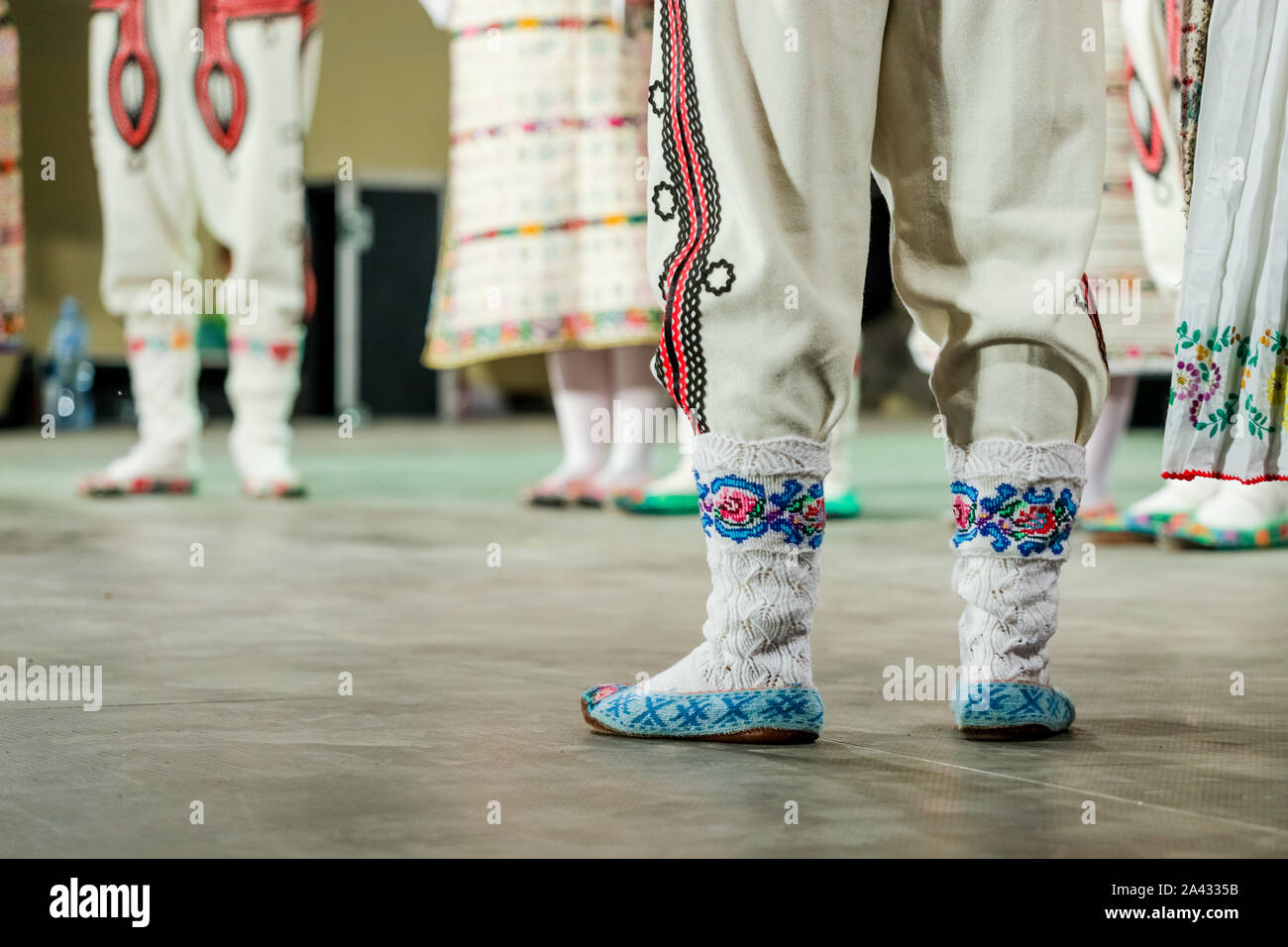 Close up of wool socks on legs of young Romanian dancer in traditional