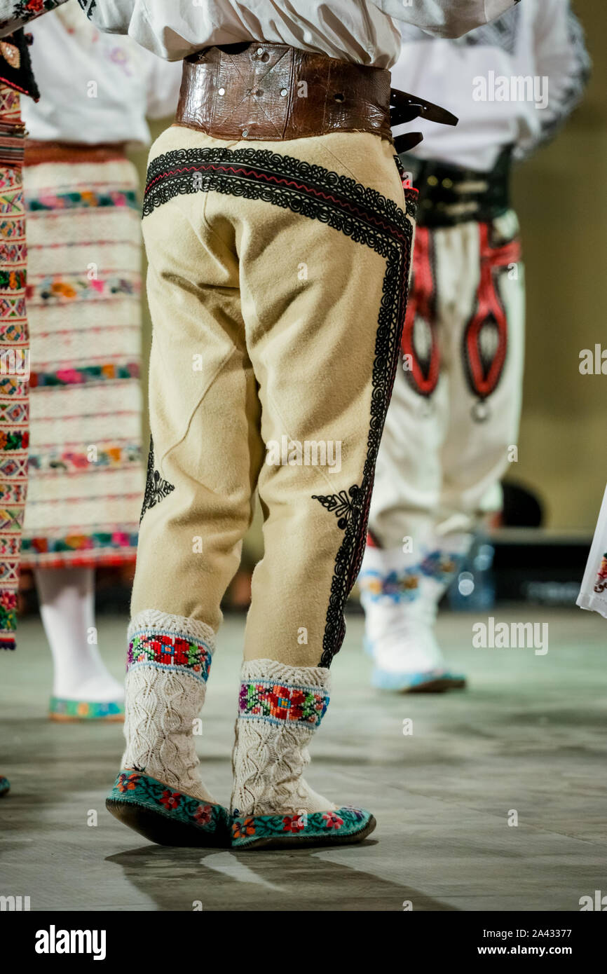 Close up of wool socks on legs of young Romanian dancer in traditional