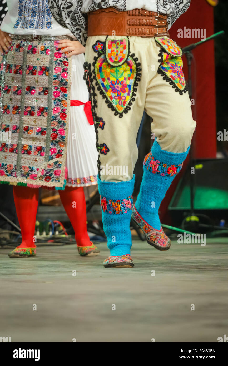 Close up of blue wool socks on legs of young Romanian dancer in