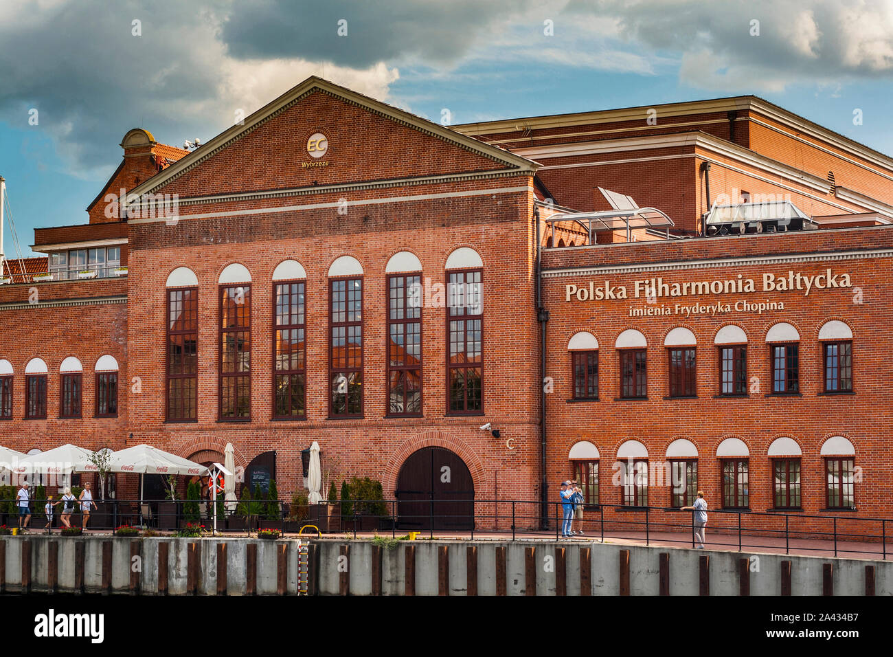 Brick-build building of  Fryderyk Chopin Polish Baltic Philharmonic Hall in Gdansk by the river Old Motlawa Stock Photo