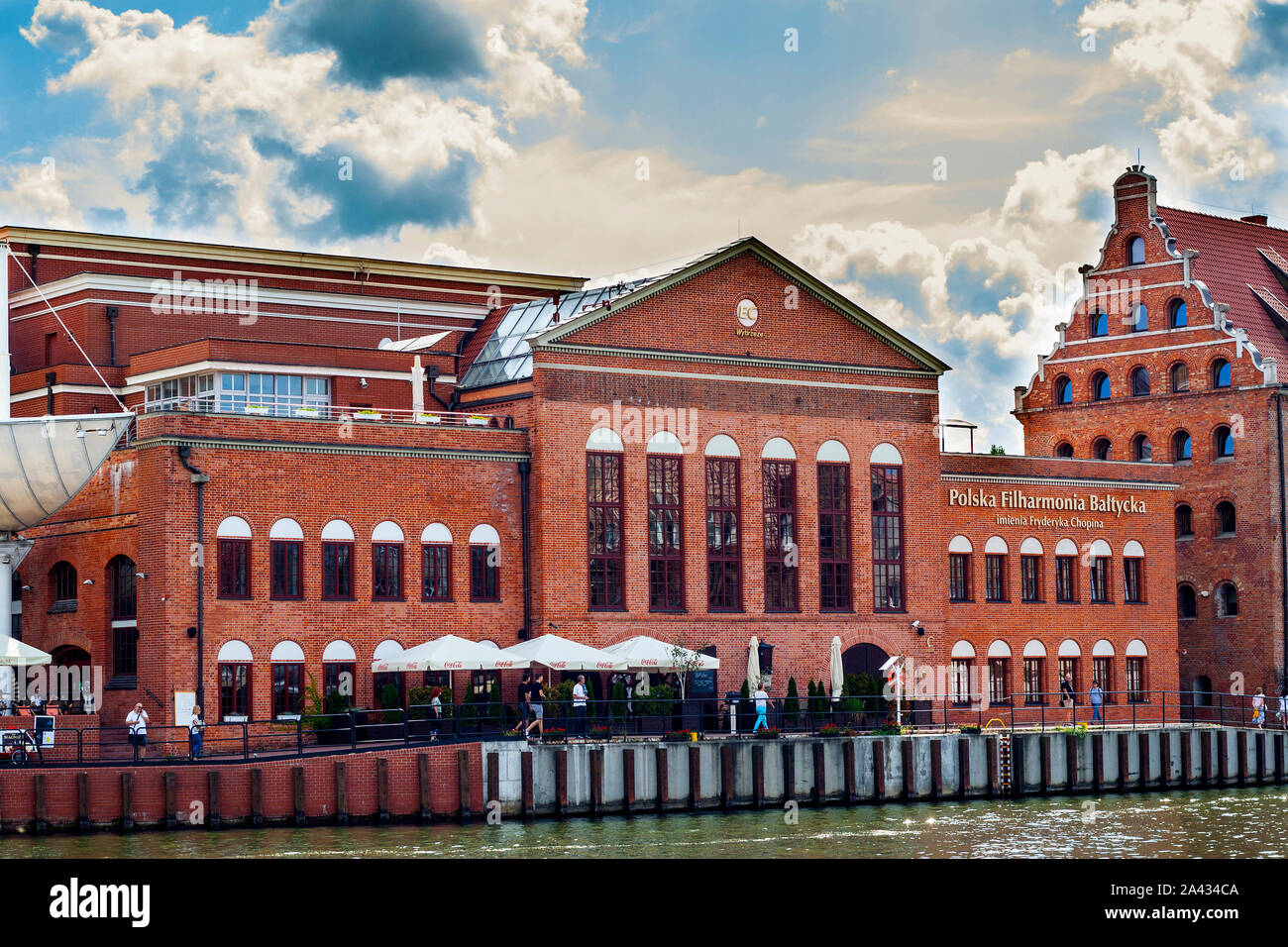 Brick-build building of  Fryderyk Chopin Polish Baltic Philharmonic Hall in Gdansk by the river Old Motlawa Stock Photo