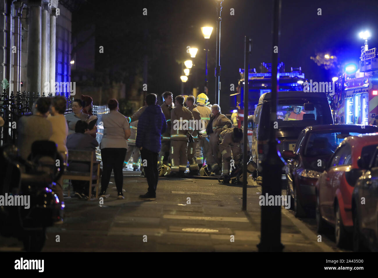 Residents and emergency personnel in the street after a fire at the