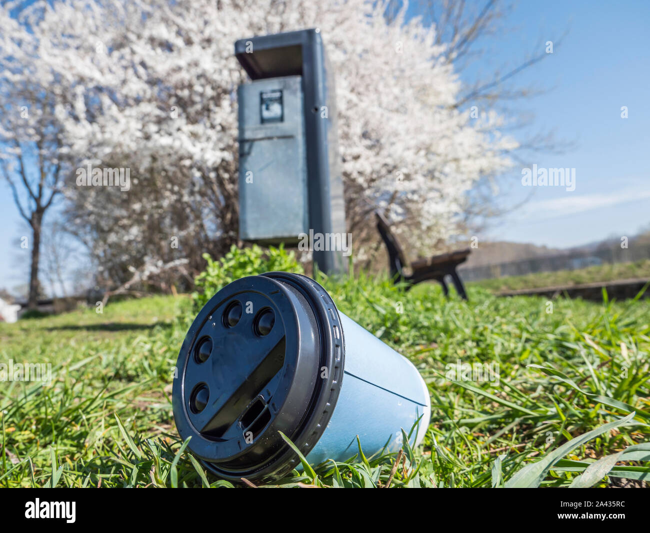 coffee to go mug in front of the trash can Stock Photo Alamy