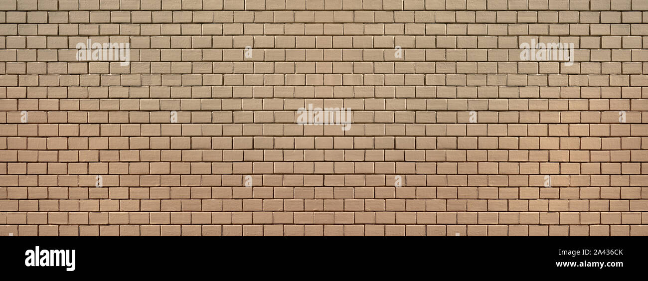 Old brick wall, completely painted over with beige paint Stock Photo