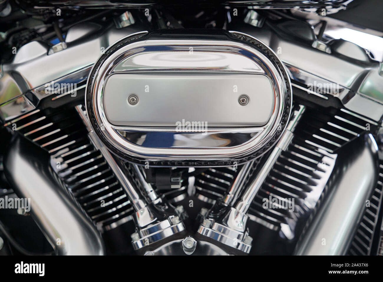 motorcycle engine chrome details close-up shot for background polished silver reflection chopper american bike cylinder exhaust pipe and pistons Stock Photo