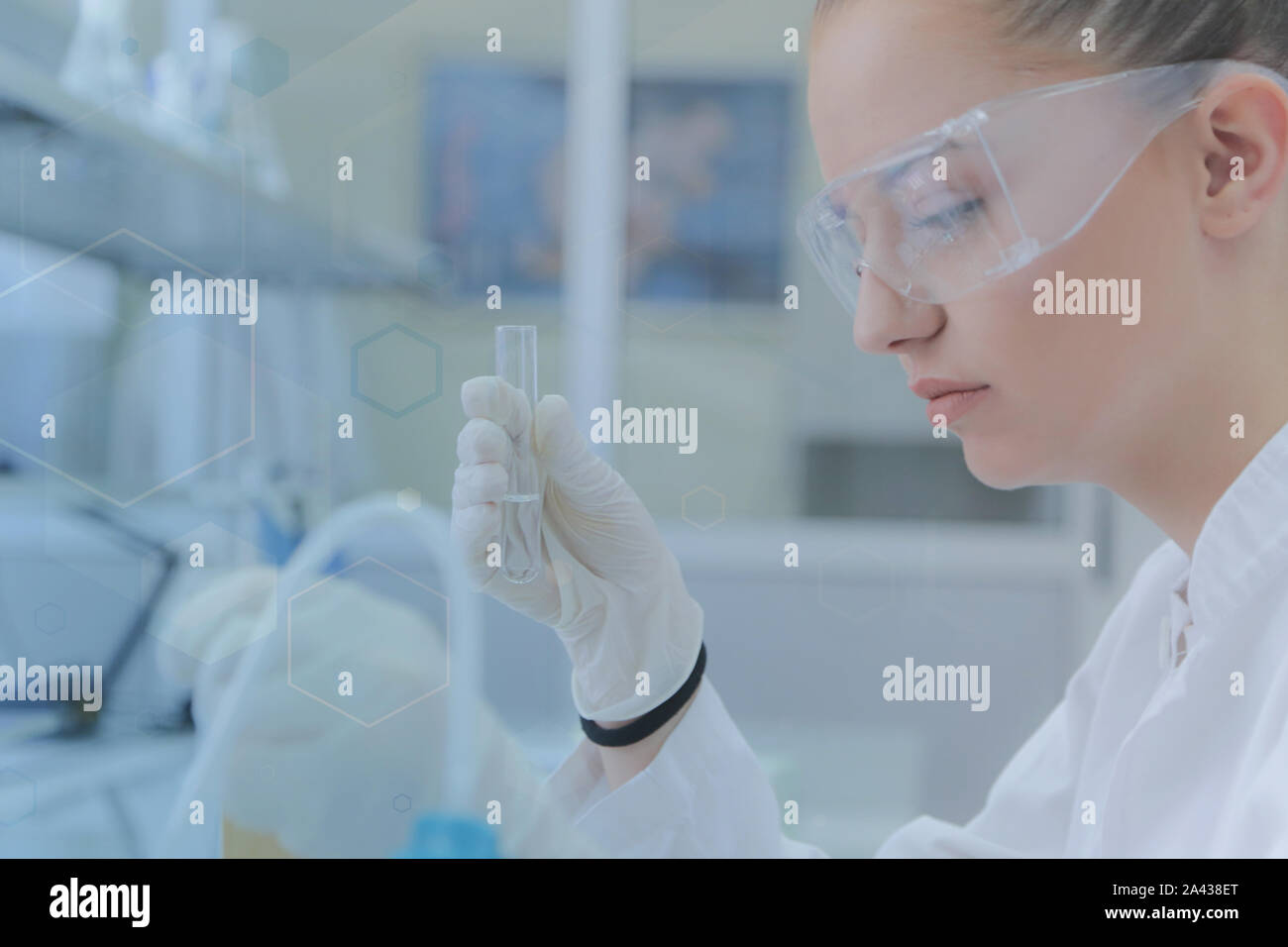 Young female scientist doing experiments in laboratory Stock Photo