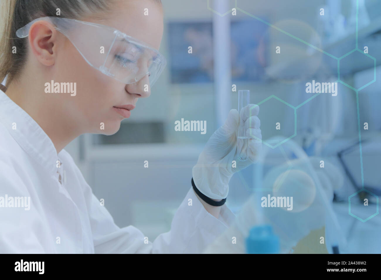 Young female scientist doing experiments in laboratory Stock Photo