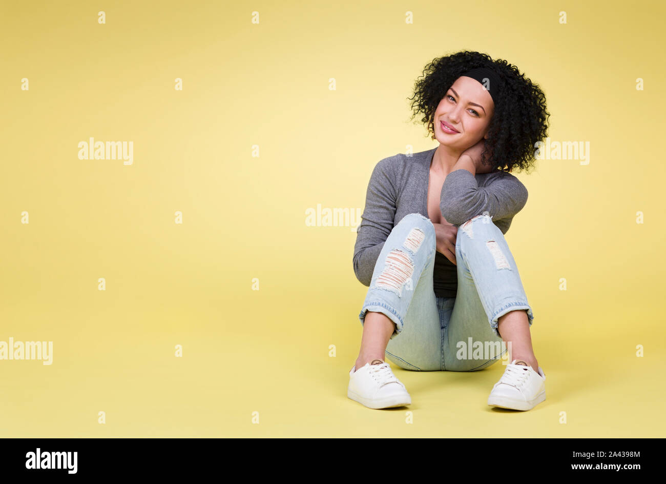 Happy woman on yellow background. Stock Photo