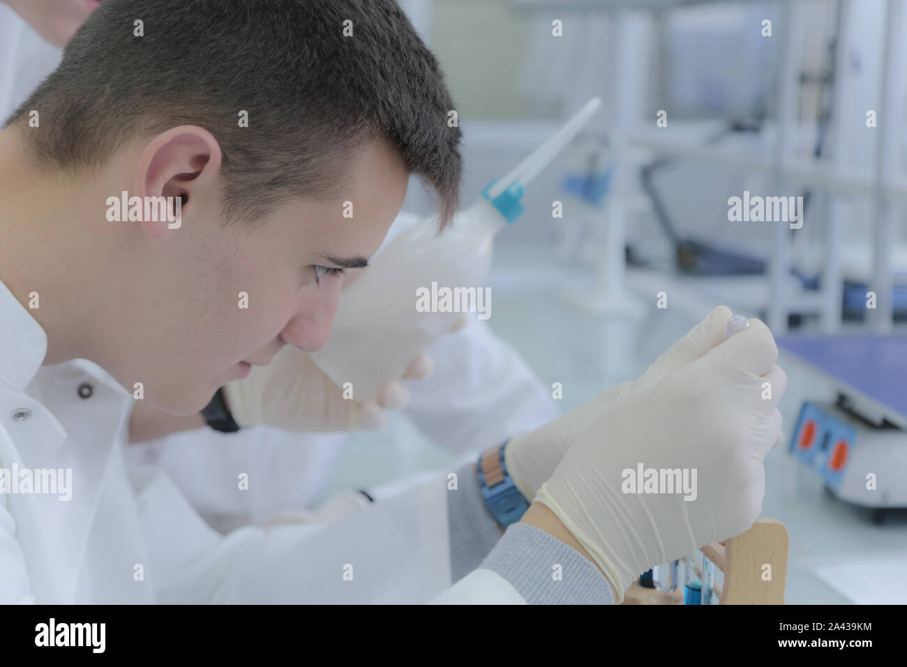 Young male scientist doing experiments in laboratory Stock Photo