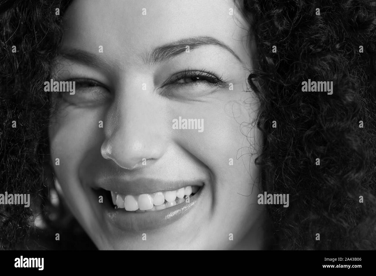 Black and white closeup of a friendly laughing woman. Stock Photo