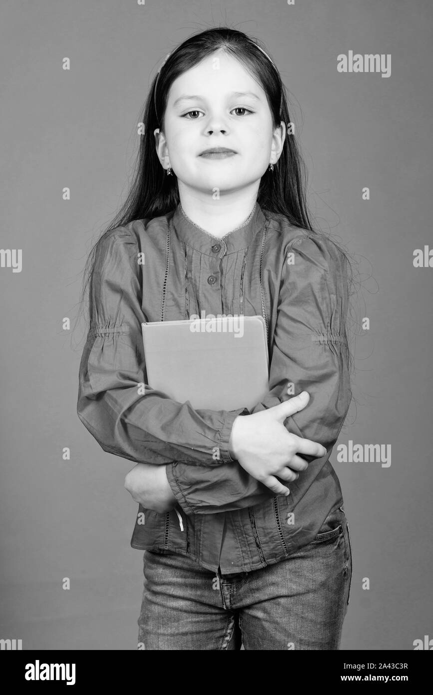 Girl hold book violet background. Kid show book. Book concept. Wise quotes. Literature club