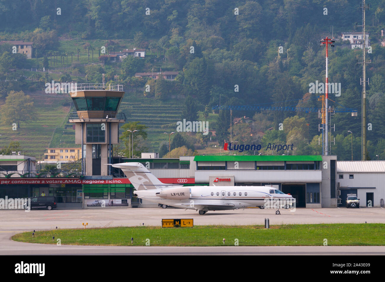 Agno, Ticino, Switzerland - 6th October 2019 : View on the Lugano-Agno airport with a parked small airplane located in the Canton of Ticino, Switzerla Stock Photo