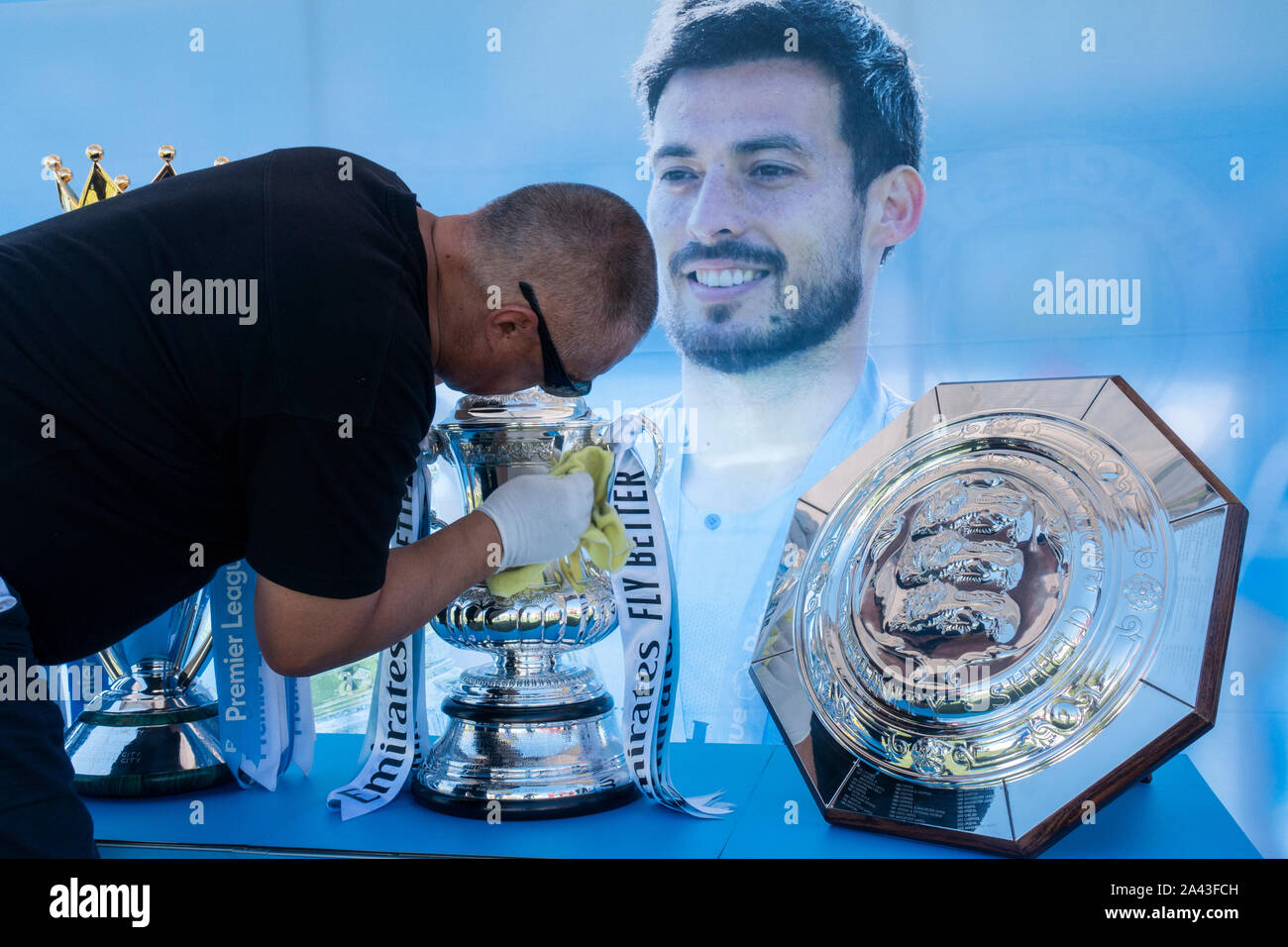 Gran Canaria, Canary Islands, Spain. 11th October, 2019. Manchester City club captain, David Silva, signs autographs and poses for photos as he showcases the clubs four trophies from last season at the ground where he started his playing career, in his hometown, Arguineguín, on Gran Canaria. The trophies have been showcased to fans in cities across the world as part of the club's Trophy Tour. PICTURED; The FA Cup is given a polish before the crowds arrive. Credit: Alan Dawson/Alamy Live News Stock Photo