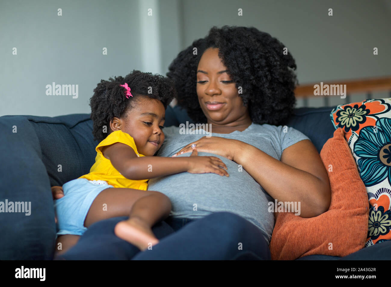 African American pregnant mother and her daughter. Stock Photo
