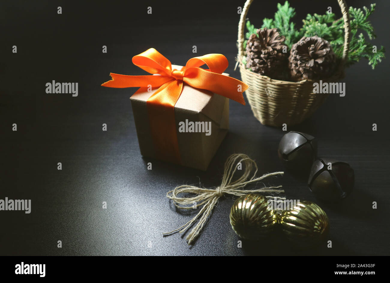 Christmas background. Gift and ornaments on dark background. Space for text. Low key photography. Stock Photo