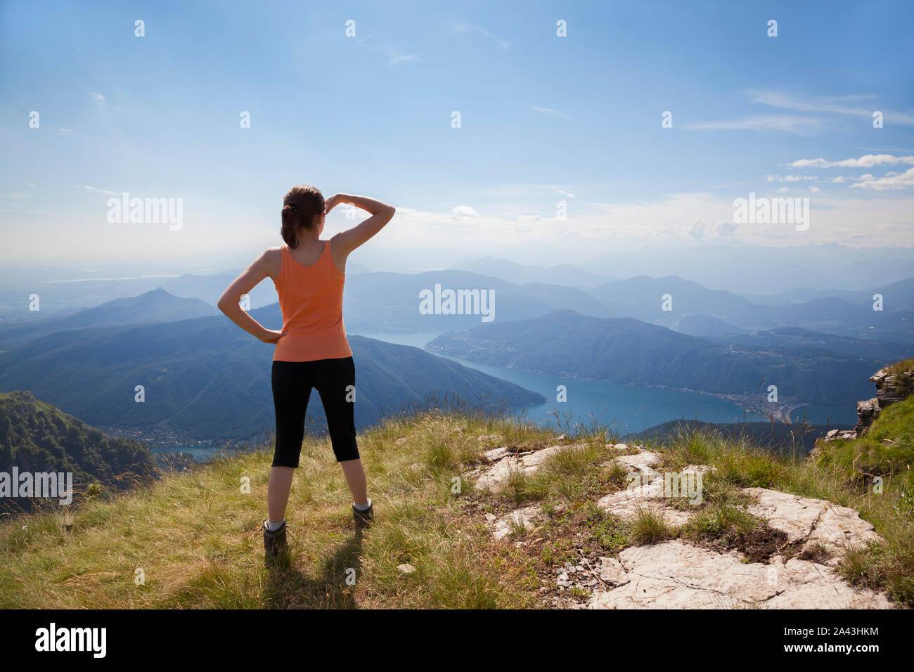 Girl on mountain top looking Stock Photo