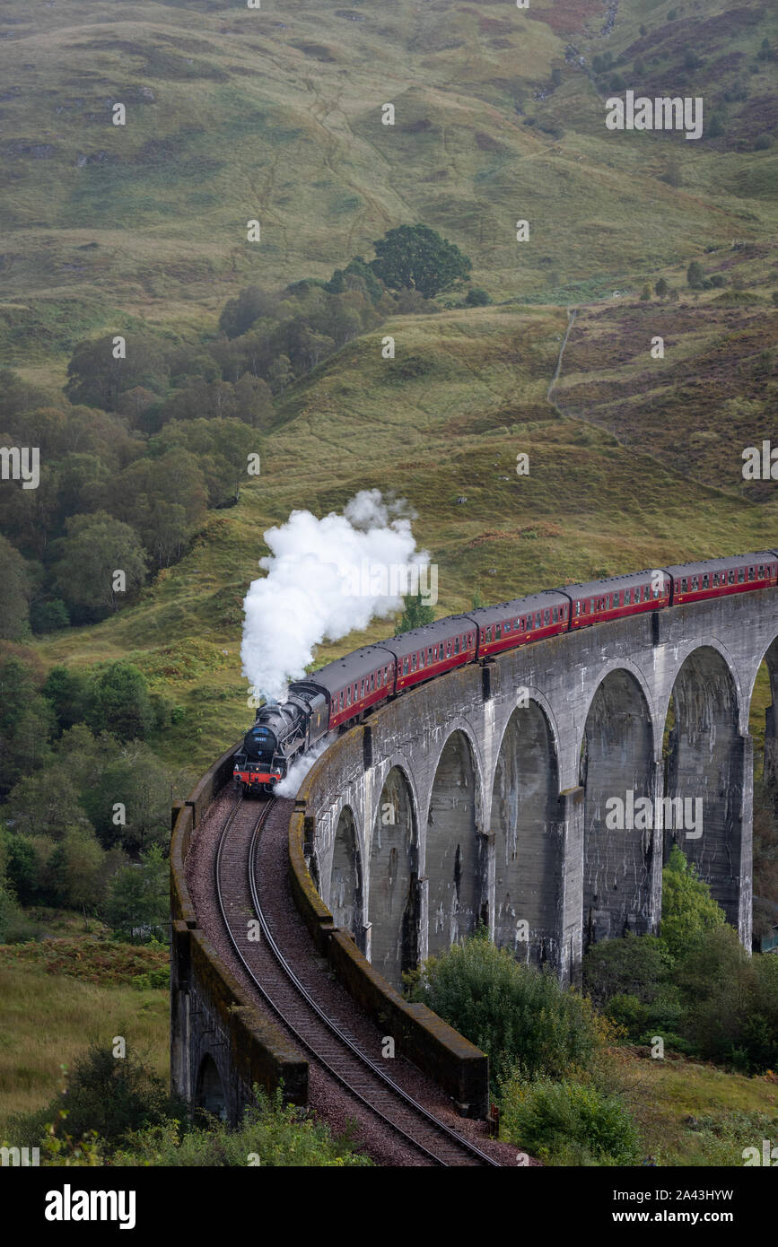 The Hogwart's Express or the Jacobite Steam Train crossing the Glenfinnan Viaduct Stock Photo