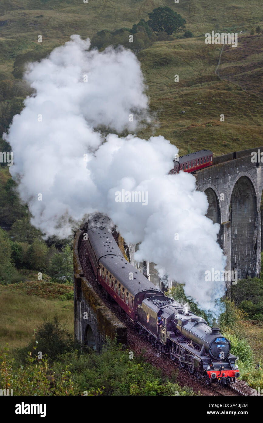 The Hogwart's Express or the Jacobite Steam Train crossing the Glenfinnan Viaduct Stock Photo