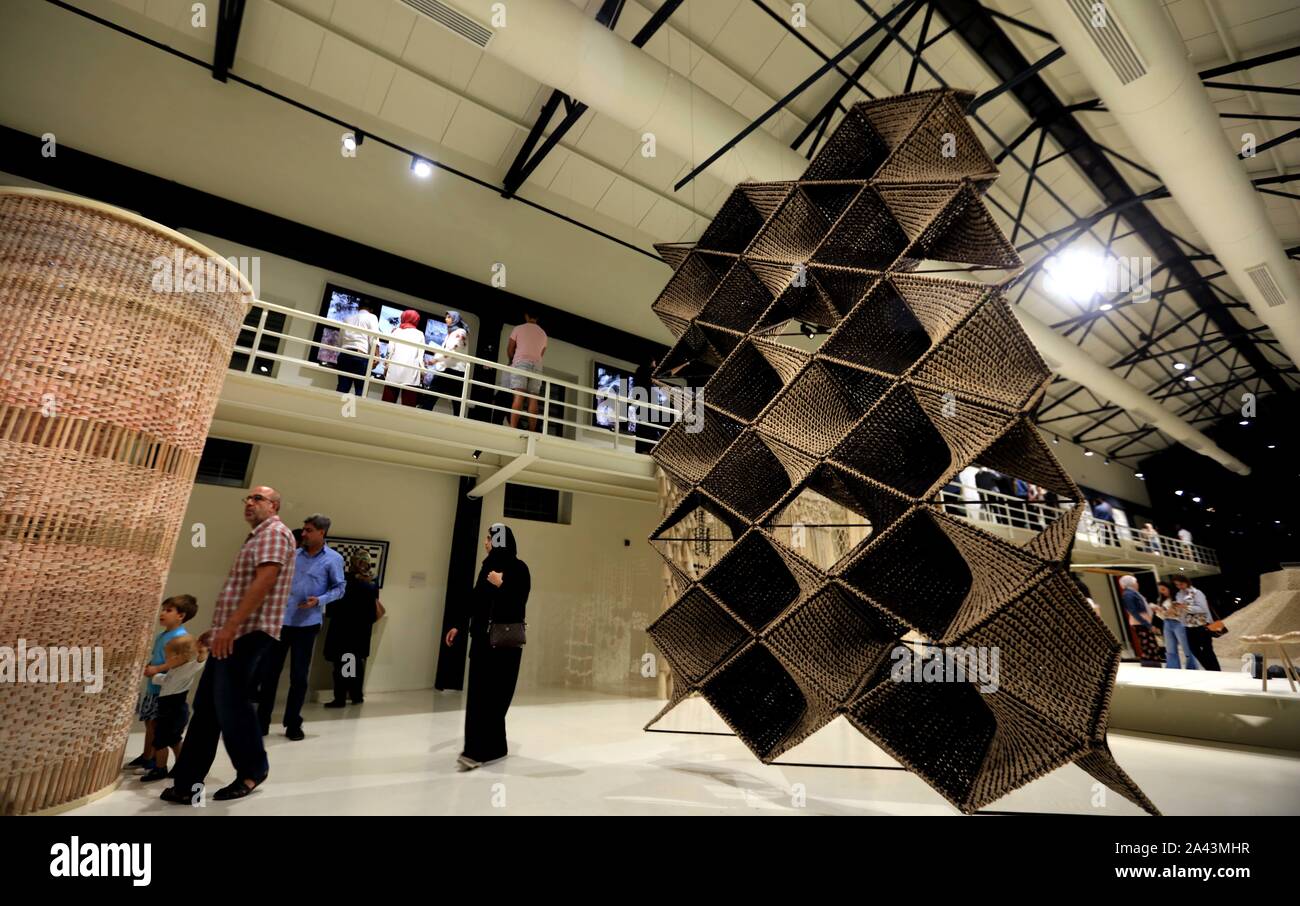 Amman, Jordan. 11th Oct, 2019. Visitors view artworks at the Hangar Exhibition in Amman, Jordan, on Oct. 11, 2019. The Hangar Exhibition, as part of Amman Design Week 2019, presents works by over fifty designers from the Middle East and North Africa. With 89,000 attendees and over 160 exhibitors and 50 participating spaces, the third Amman Design Week takes place in Amman from Oct. 4 to Oct. 12. Credit: Mohammad Abu Ghosh/Xinhua/Alamy Live News Stock Photo