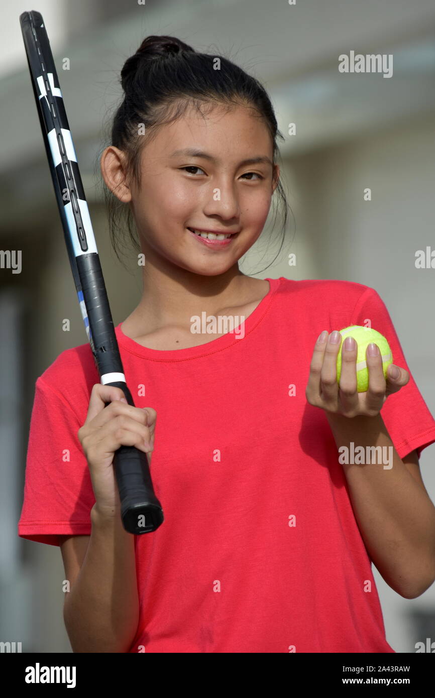 Asian Female Tennis Player And Happiness With Tennis Racket Stock Photo