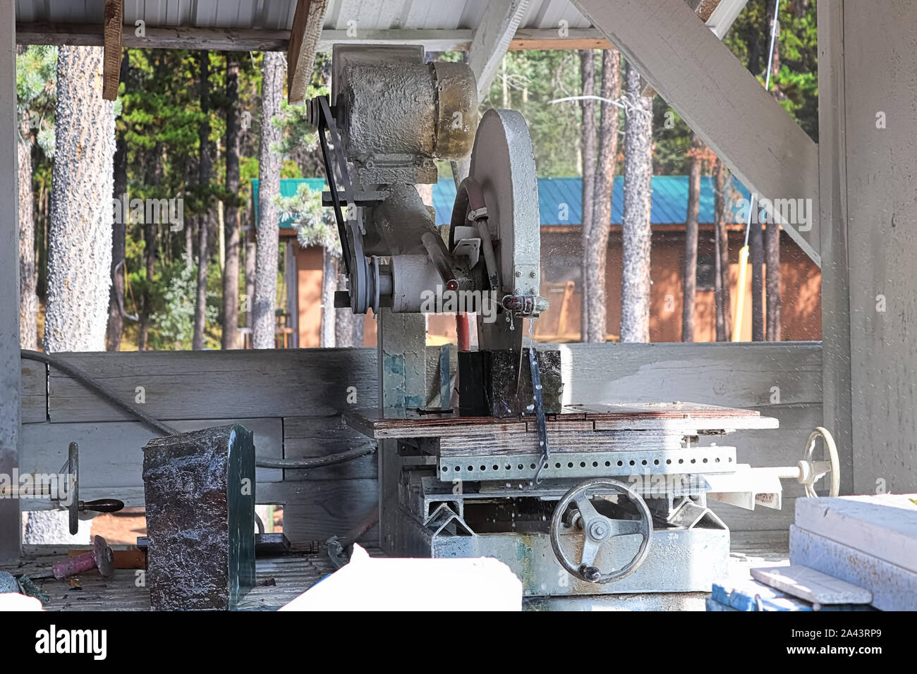 A large steel blade cuts through a block of jade Stock Photo Alamy