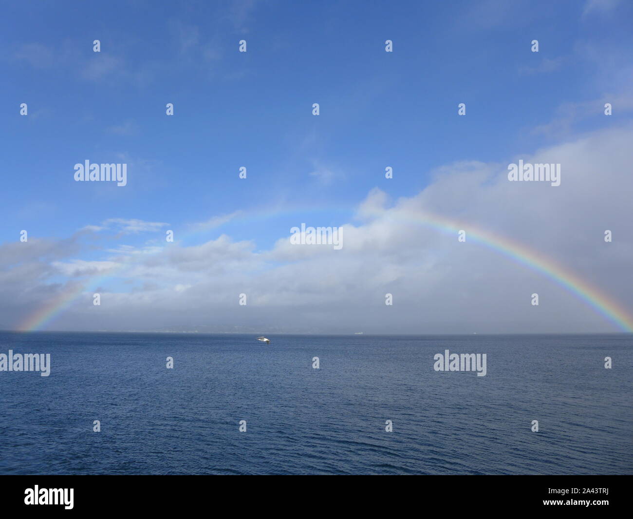 Rainbow over the sea Stock Photo