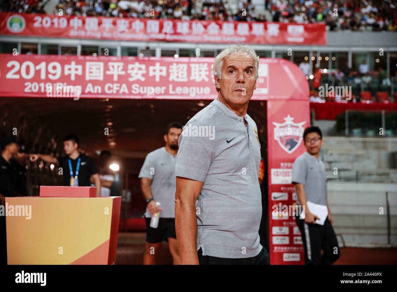 Head coach Roberto Donadoni of Shenzhen F.C. reacts as he watches his players competing against Beijing Renhe in their 21st round match during the 201 Stock Photo