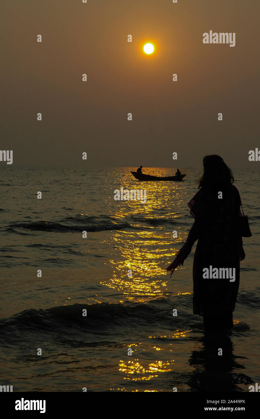 A tourist enjoying sunset at Kuakata sea beach. Patuakhali, Bangladesh Stock Photo