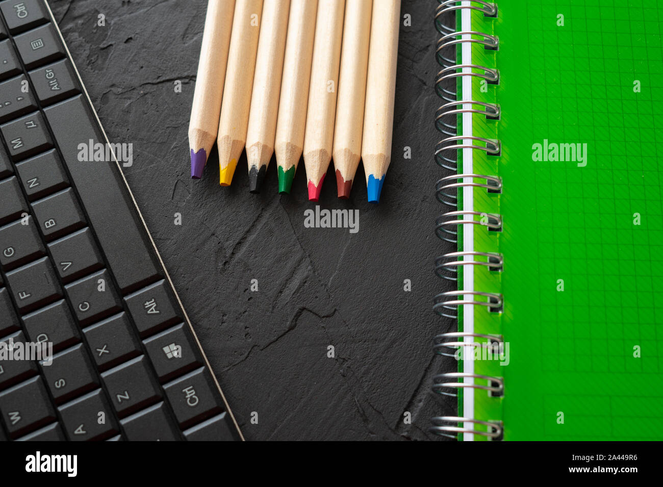 Back to school background with green spiral ring bound notebook