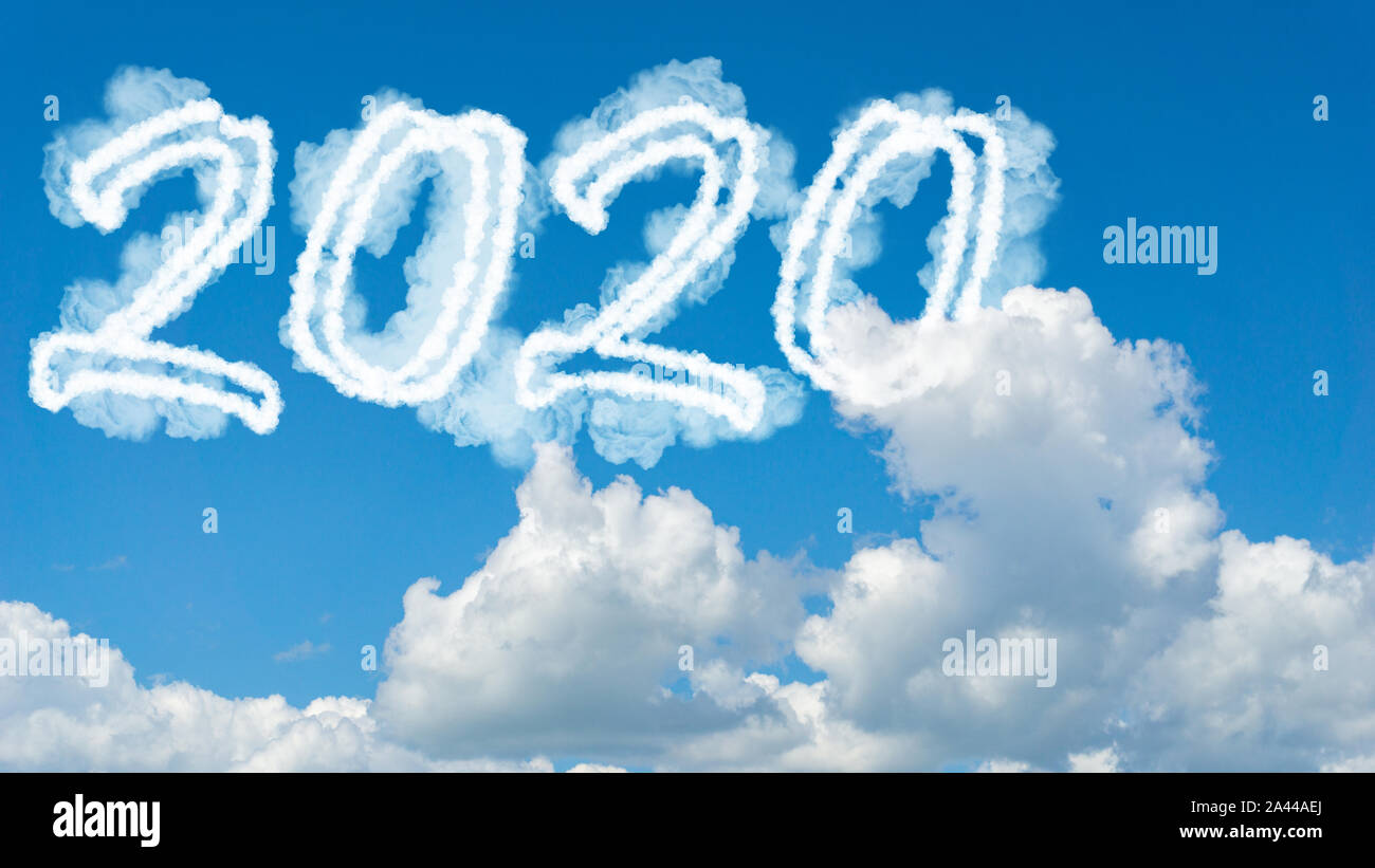 Sunny sky cloud year 2020. Happy New year concept. Numbers 2020 symbol inscription on background of blue sky from white smoke of clouds with bright su Stock Photo