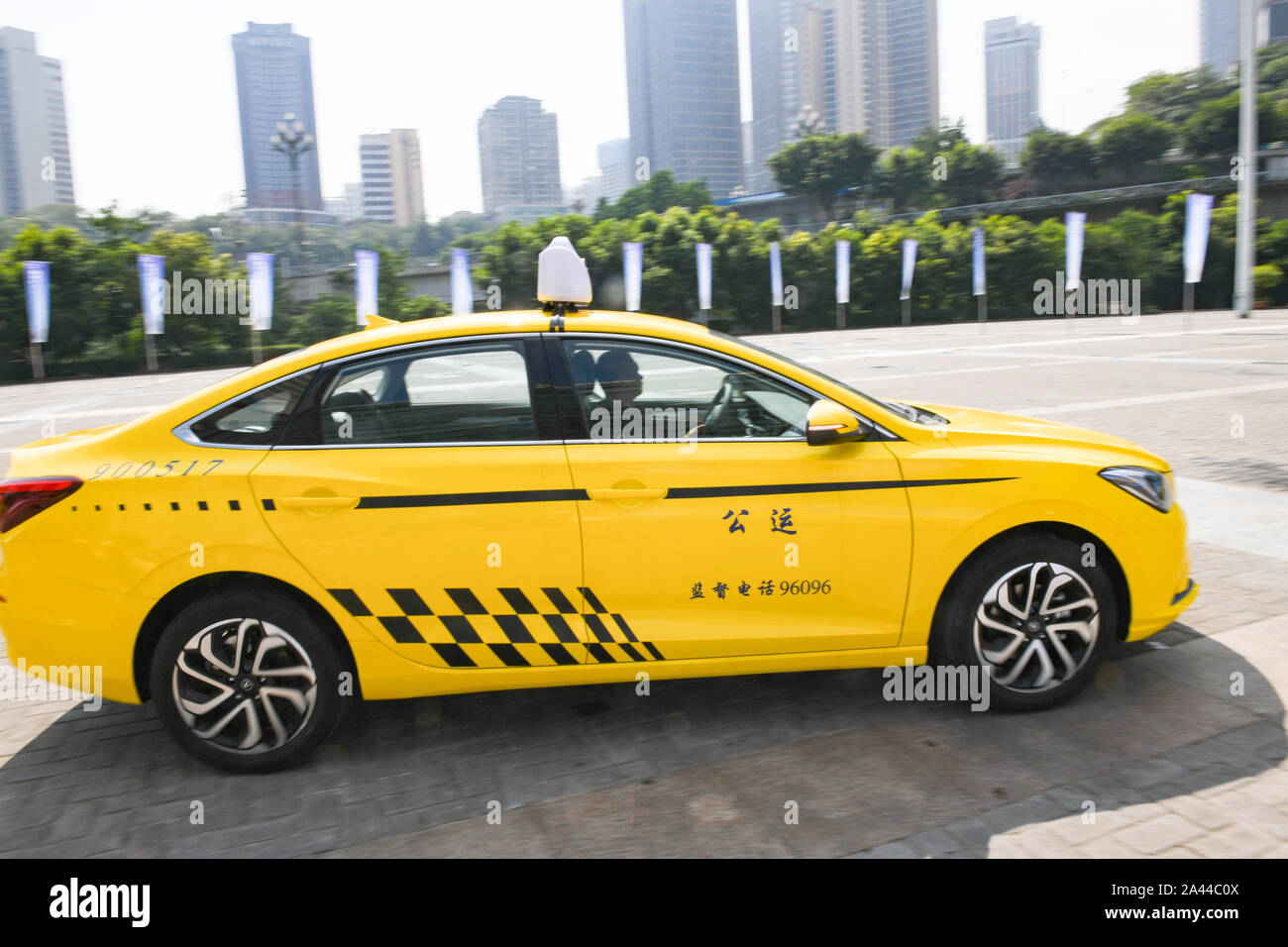 Rows of electric taxis to reduce car emissions and improve the air quality are parked in Chongqing, China, 1 August 2019. A fleet of electric taxis ha Stock Photo