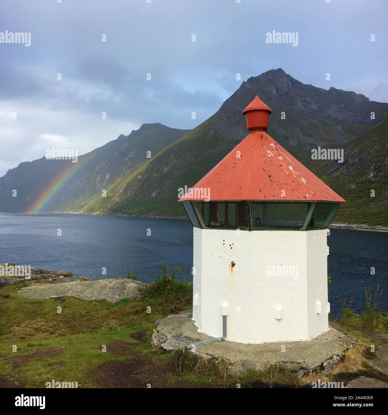 A magical moment. In the background, a rainbow appears and the gigantic mountains fit in with it. Stock Photo
