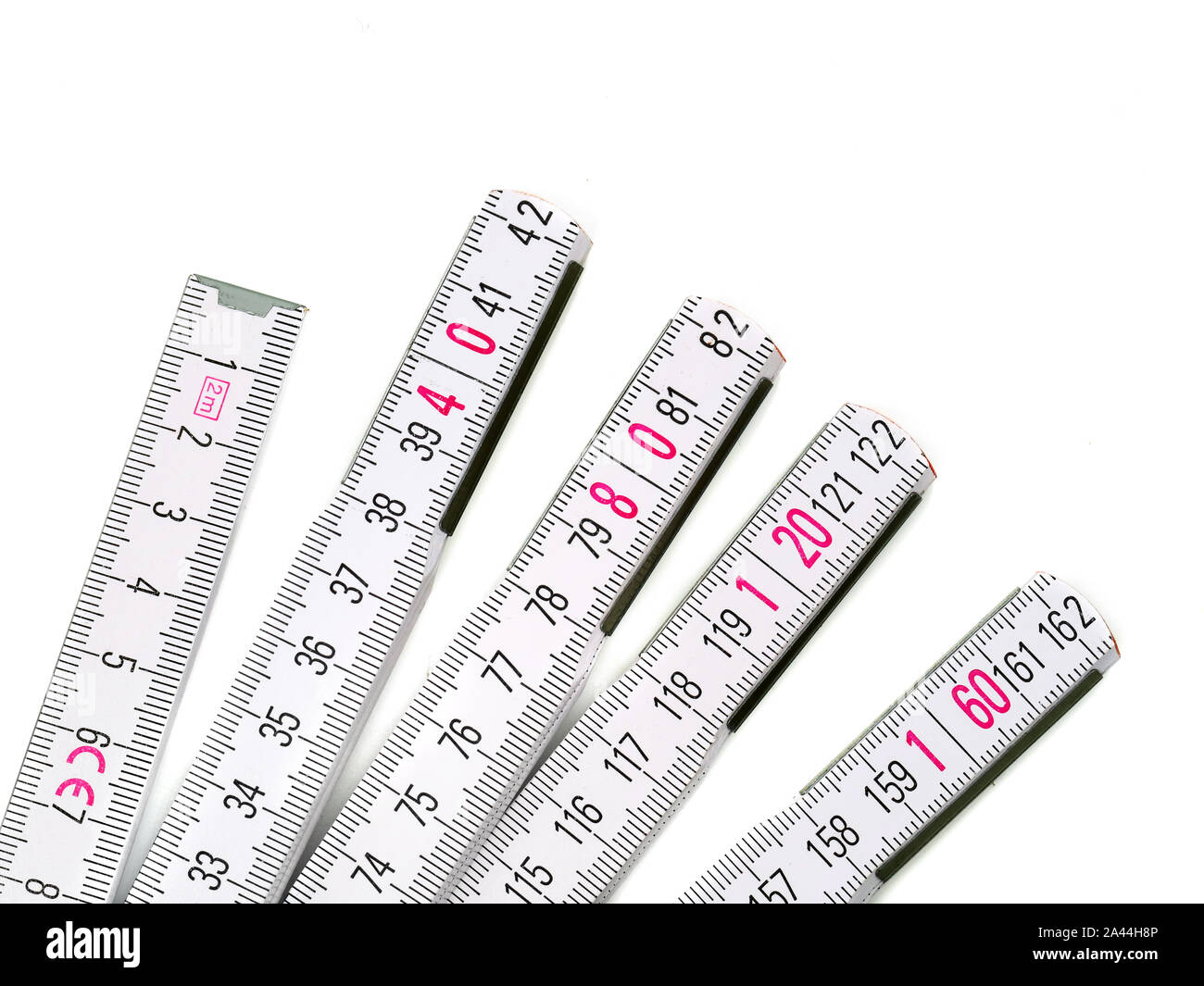 Close up of white yardstick with pink numbers isolated on white background Stock Photo