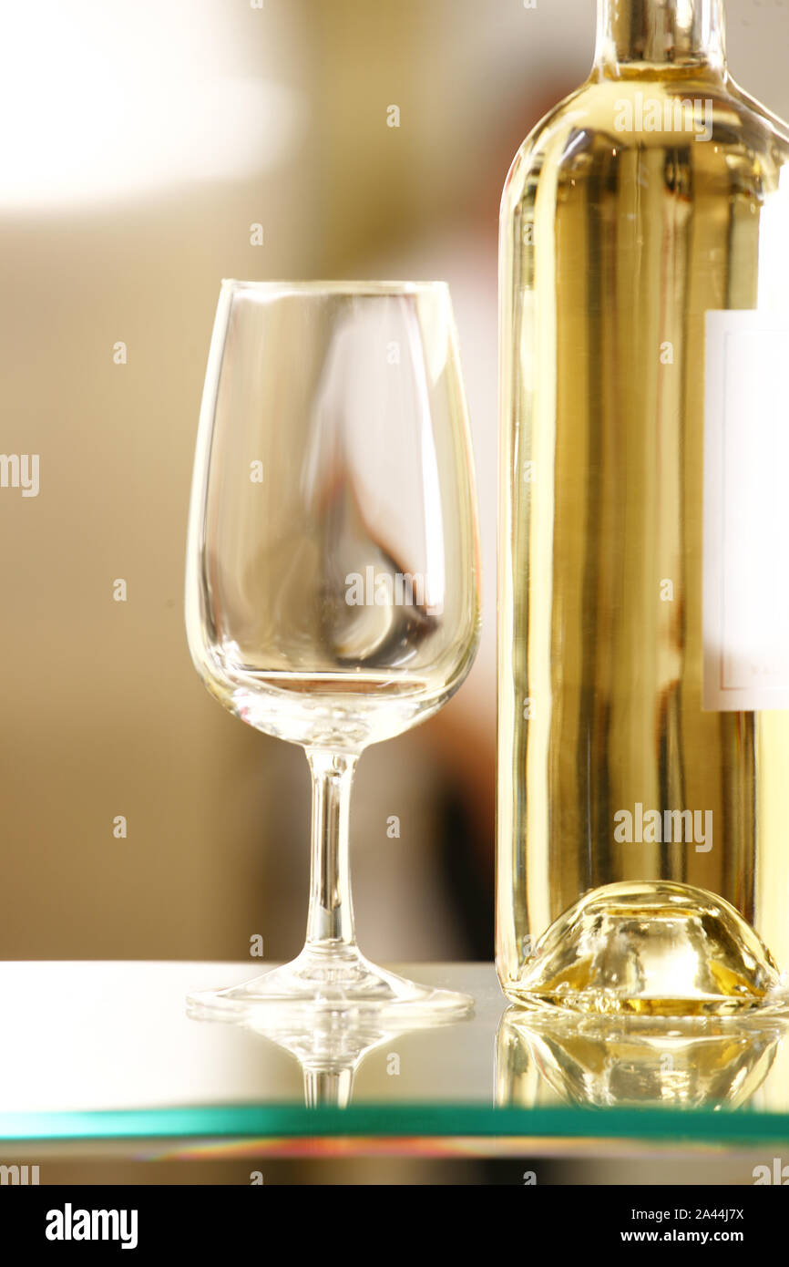 White wine glass with white wine buttle Stock Photo Alamy