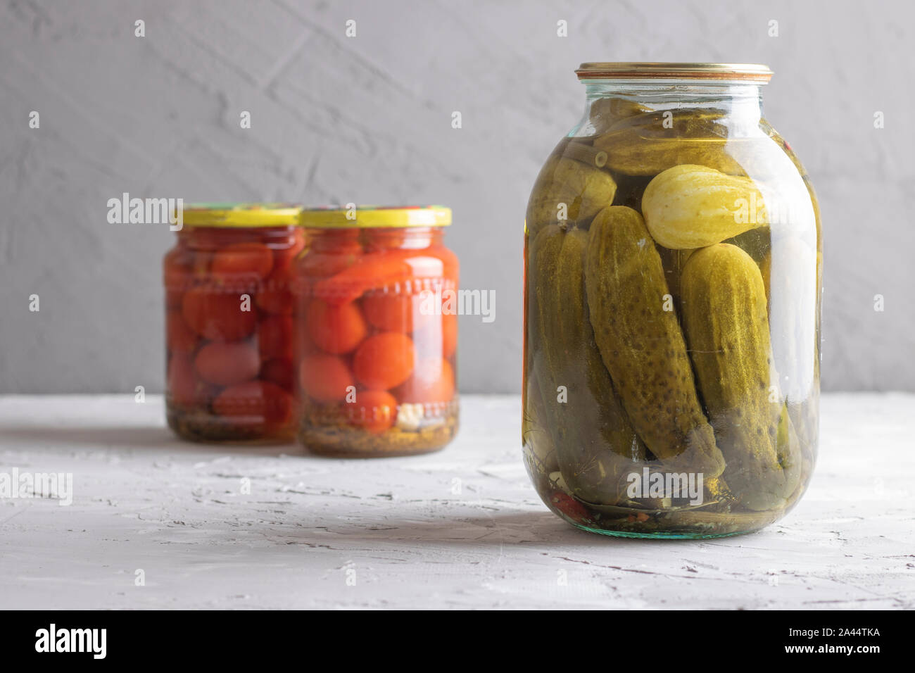 Pickled vegetables in jars, tomatoes and cucumbers Horizontal Stock Photo