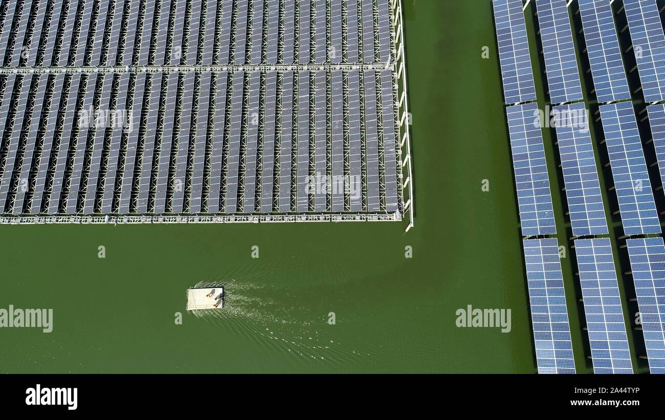 Aerial view of solar panels set at a fishing ponds, where fishermen ...