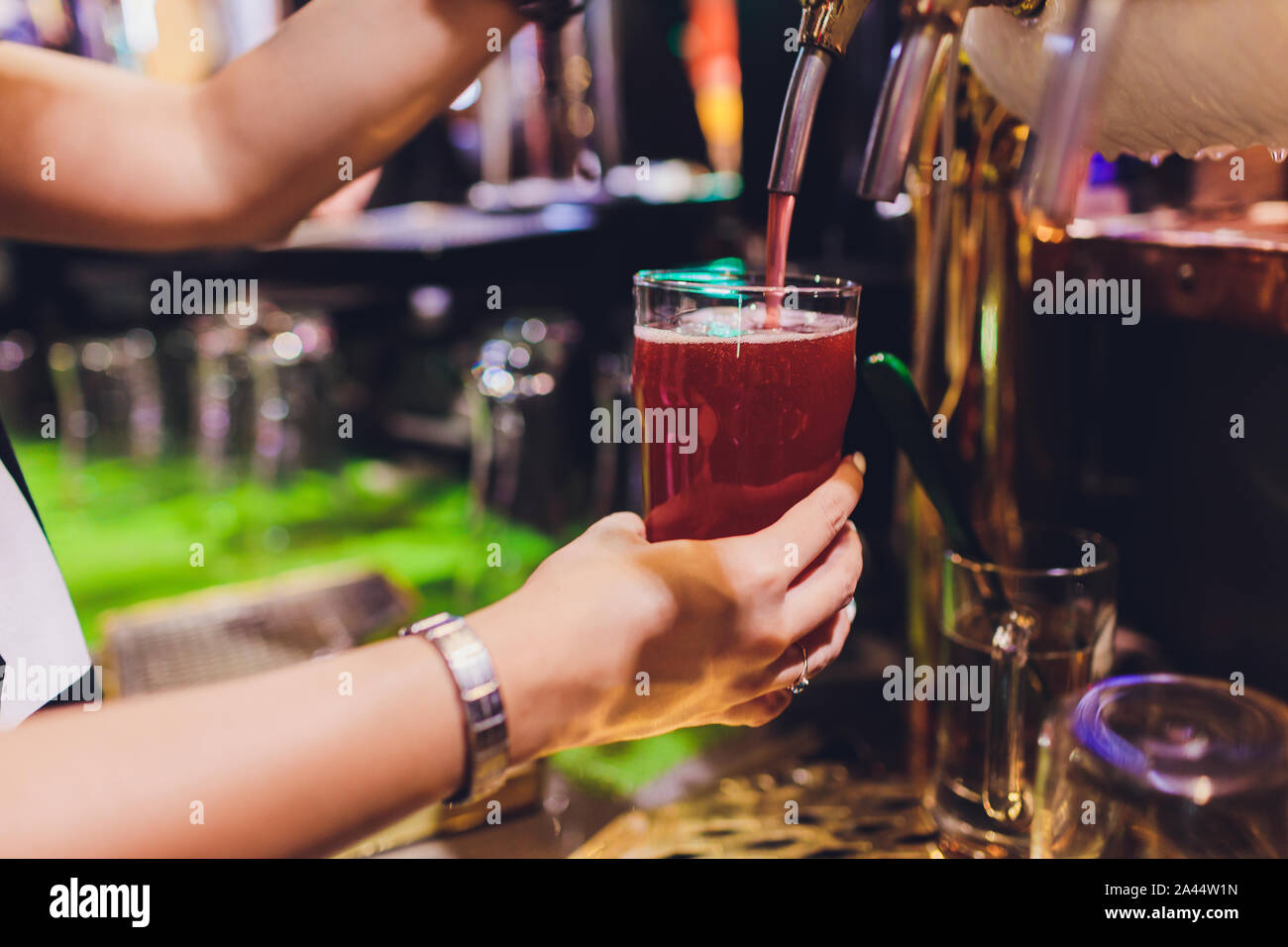 Close Up Of A Male Bartender Dispensing Draught Beer In A Pub Holding A 