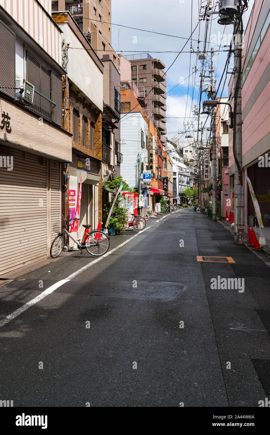 Tokyo, Japan - August 29, 2016: Back street with parked bicycles on early morning. Green transport. Taito district, Tokyo, Japan Stock Photo