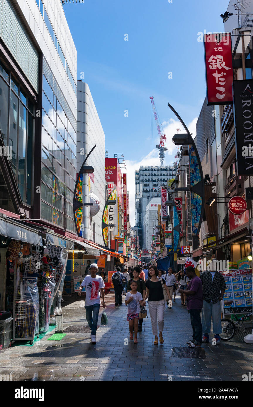 Tokyo, Japan - August 29, 2016: Ameyoko outdoor market near Ueno station. Text in Japanese advertise market name and vendor shops including watches, c Stock Photo
