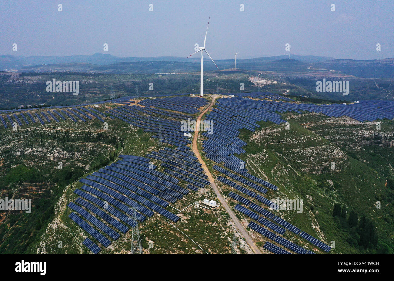 Aerial view of the hybrid power plant of both solar and wind power, which is capable of generating 870 million kWh annually, established in Shanting d Stock Photo