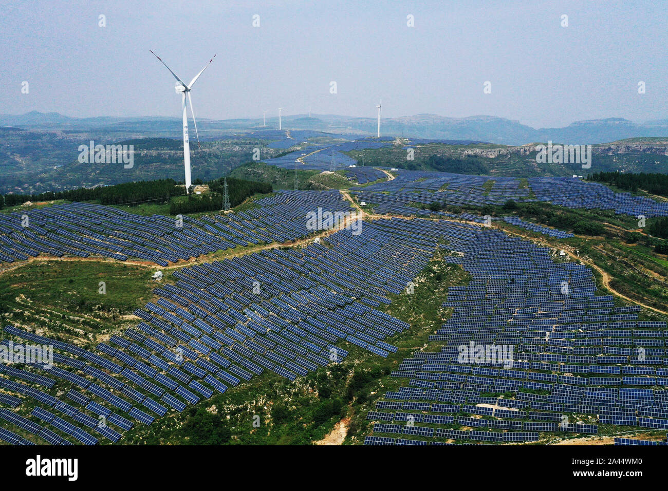Aerial view of the hybrid power plant of both solar and wind power, which is capable of generating 870 million kWh annually, established in Shanting d Stock Photo