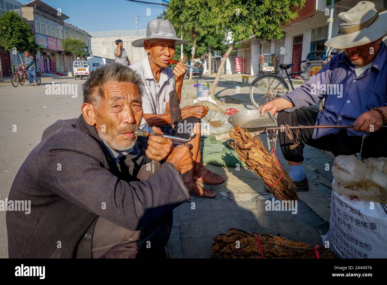Young Rural Smokers Local villagers are smoking by the selling stand of the 85-year-old ...