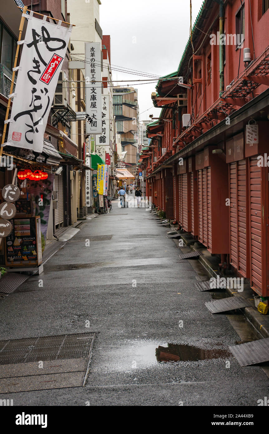 Tokyo, Japan - Aug 29, 2016: side street with people in the distance and local ice cream shop and cafes near Senso-ji temple, Asakusa district. Small Stock Photo