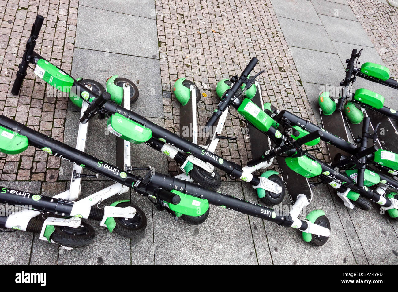 Electric scooters lying on the ground, obstruct the pavement, sidewalk, Prague street Czech Republic Stock Photo