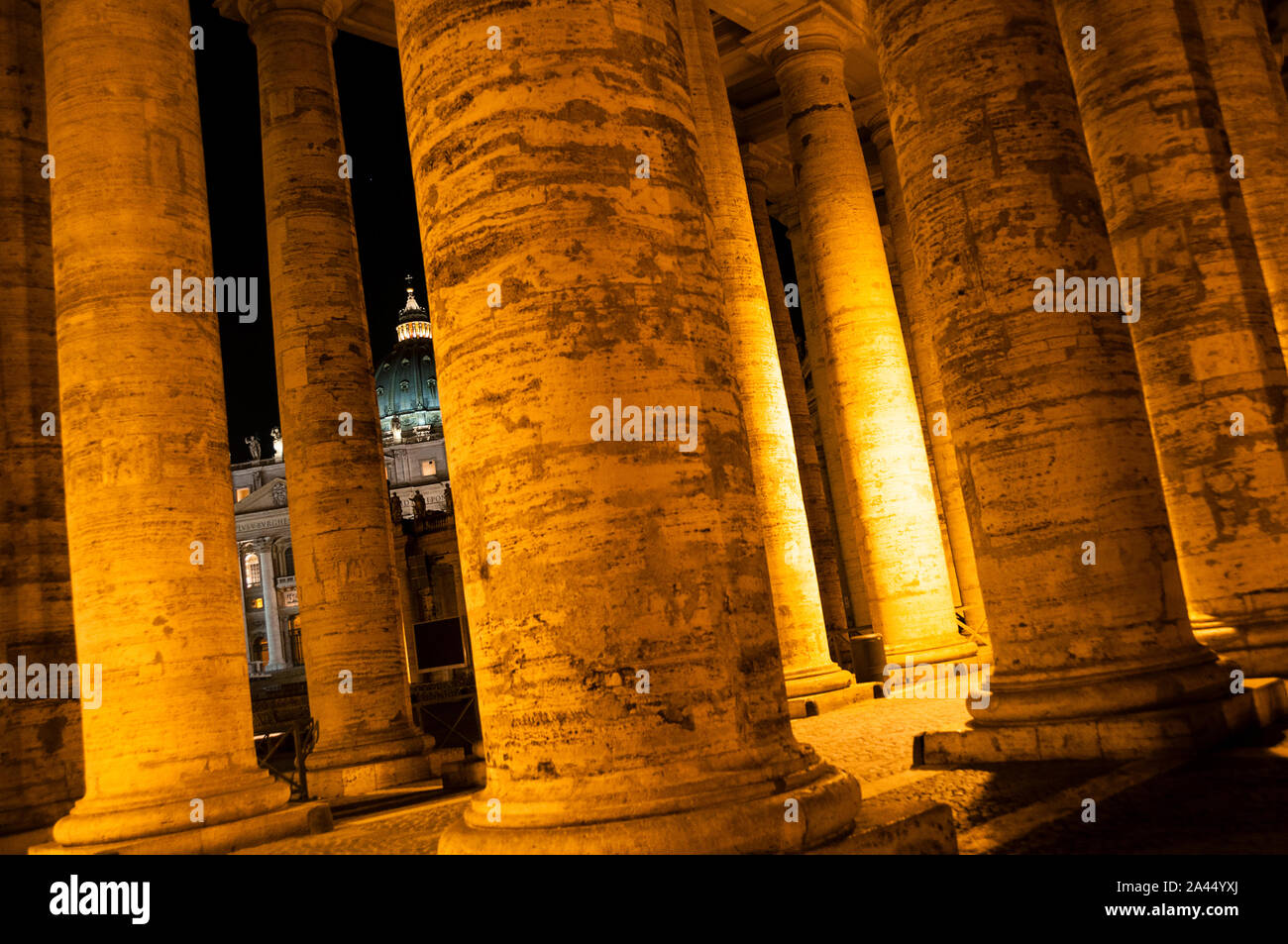 The Dome of St Peters's Basilica seen through massive pillars Stock