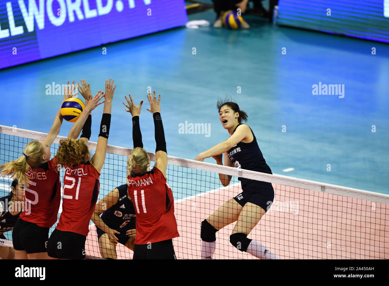 A member of China women's national volleyball team, left, smashes the ball during the 2019 FIVB Women's Volleyball Intercontinental Olympic Qualificat Stock Photo