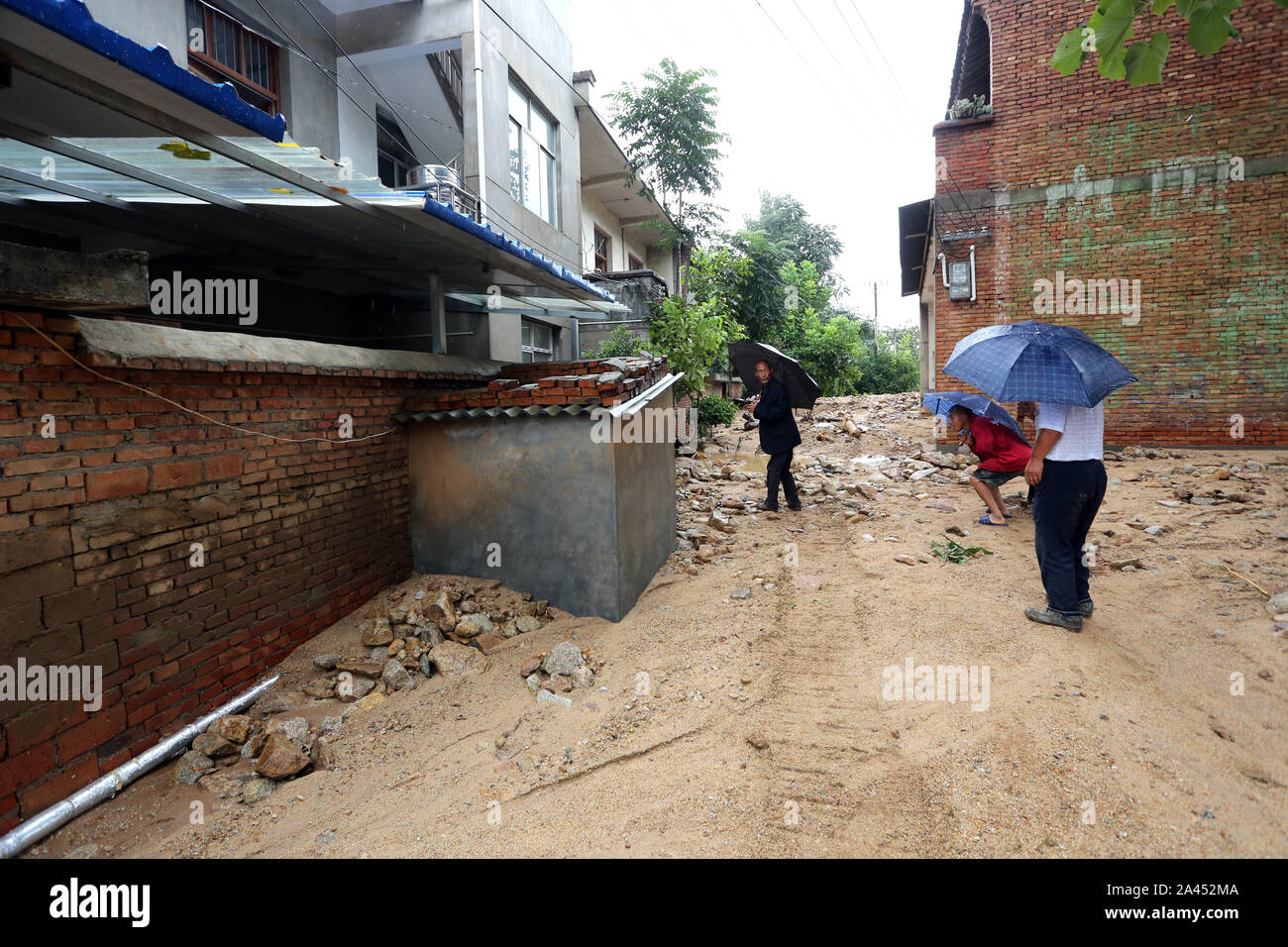 Villagers check the destruction caused by mountain torrents and take