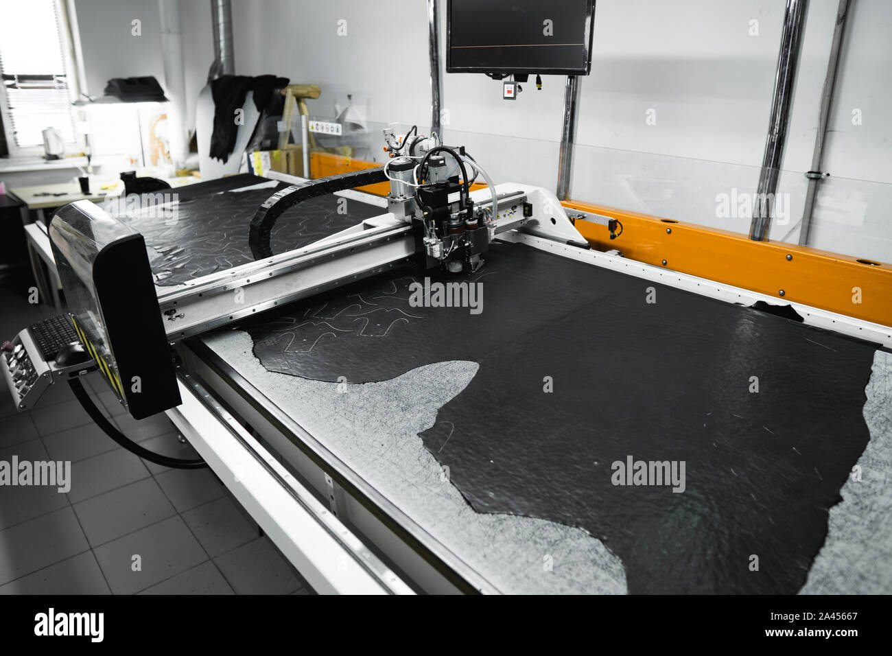 CNC machine for cutting fabrics textile materials and leather. Modern footwear production