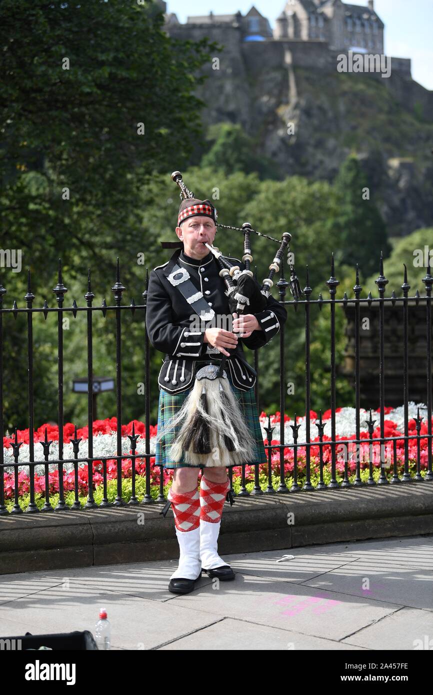 Lone Scottish Piper at the East end of Princess Street Gardens entertaining the City's visitors. Stock Photo