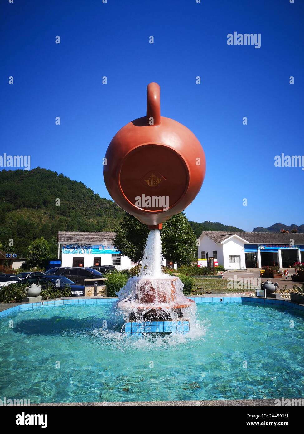 A giant floating teapot and teacup water fountain is displayed at an expressway service area in